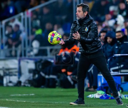Photo for Madrid, Spain- January 28, 2023: Soccer match between Real Betis balonpie and Getafe F.C in Madrid. The coach of Getafe F.C,  Sanchez Flores in the band with the ball. - Royalty Free Image
