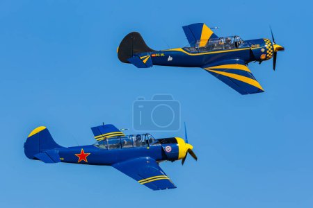 Photo pour Madrid, Spain- February 5, 2023: Air show of vintage airplanes over the sky of Madrid. Yakovlev Yack 52 model stunt plane. old planes - image libre de droit