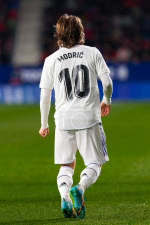 Photo for Madrid, Spain- February 18, 2023: League match between Real Madrid and Osasuna in Pamplona. Luka Modric with his back turned, walking through the field. Real Madrid player. - Royalty Free Image
