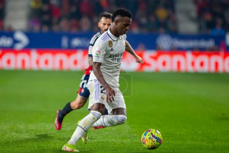 Photo for Madrid, Spain- February 18, 2023: League match between Real Madrid and Osasuna in Pamplona. Vinicius Jr. fighting for the ball. Football games. Real Madrid player. - Royalty Free Image