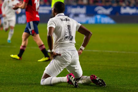 Photo for Madrid, Spain- February 18, 2023: League match between Real Madrid and Osasuna in Pamplona. David Alaba on his knees in the field lamenting. Football game. Real Madrid player. - Royalty Free Image
