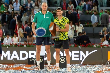 Photo for Madrid, Spain- May 5, 2023: Tennis match at the Mutua Madrid Open between Carlos Alcaraz and Struff. Alcaraz winner of the Mutua Madrid Open 2023. Carlos Alcaraz with the winner's trophy. - Royalty Free Image