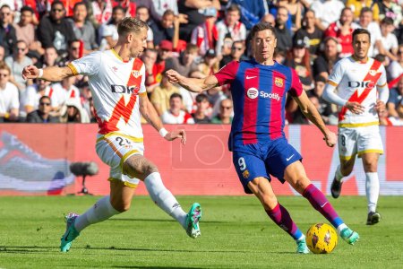 Photo for Madrid, Spain- November 25, 2023: League match between Rayo Vallecano and F.C Barcelona in Madrid. Lewandoski with the ball. Football players. - Royalty Free Image