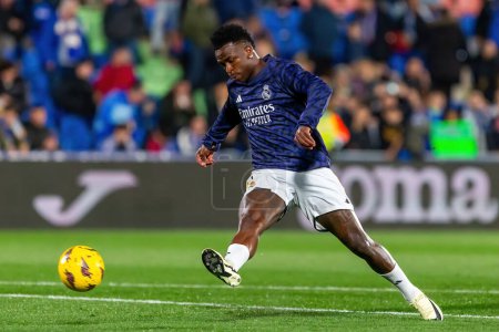 Photo for Madrid, Spain- February 1, 2024: League match between Getafe f.c and Real Madrid played in the capital. Vinicius Jr with the ball. Football players. - Royalty Free Image