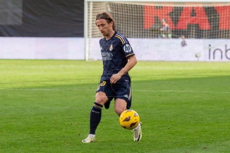 Photo for Madrid, Spain- February 18, 2024: League match between Rayo Vallecano and Real Madrid played in the capital. Luka Modric during the match. Madrid derby. Professional soccer players. - Royalty Free Image