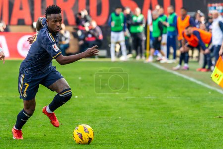 Photo for Madrid, Spain- February 18, 2024: League match between Rayo Vallecano and Real Madrid played in the capital. Vinicius during the match. Madrid derby. Professional soccer players. - Royalty Free Image