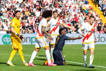 Photo for Madrid, Spain- February 18, 2024: League match between Rayo Vallecano and Real Madrid played in the capital. Vinicius during the match. Madrid derby. Professional soccer players. - Royalty Free Image