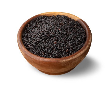 Raw black rice in a bowl isolated over white background.