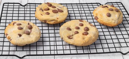 Téléchargez les photos : Biscuits aux pépites de chocolat sur une grille métallique sur une table en marbre. - en image libre de droit