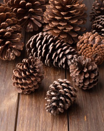 Photo for Group of pinecones over wooden table. - Royalty Free Image