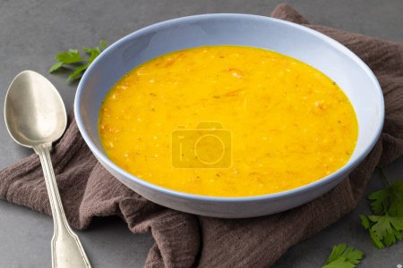 Photo for Pumpkin and jerked beef soup in a bowl over stone background. - Royalty Free Image