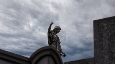 Photo for Woman stone sculpture placed on top of a mausoleum at Recoleta cemetery - Royalty Free Image