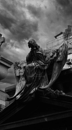 Photo for Close view of an angel stone sculpture, placed on top of an old mausoleum in Recoleta cemetery - Royalty Free Image