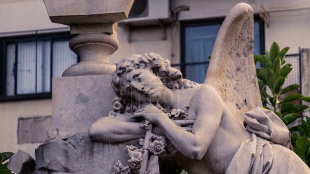 Photo for Close view of an angel stone sculpture, placed on top of an old mausoleum in Recoleta cemetery - Royalty Free Image