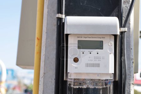 Foto de Digital electricity meter on pole. Closeup smart meter controlled and communicated via RF radio to mobile phones and Wi-Fi devices in real time with selective focus. - Imagen libre de derechos