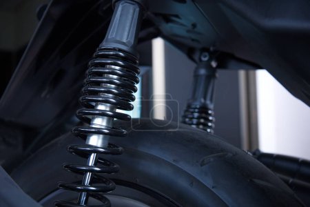 Motorcycle rear spring shock absorber. Motorcycle rear wheel suspension with copy space with selective focus
