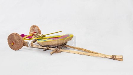 Photo for Tomtom gari. traditional handmade new year carnival wagon toy of Boishakhi mela in Bangladesh. made of clay wheel drum and bamboo stick tighten with string. it bits the drum and sounds while dragging. - Royalty Free Image