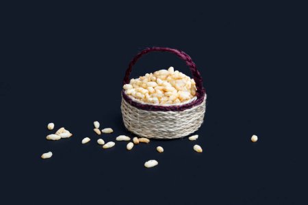 Puffed rice in a jute basket isolated on black background.
