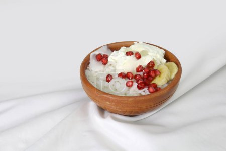 Doi Chira on clay bowl, traditional Bangale healthy and ice cool summer food . Main ingredient is water soaked flatten rice and curd. Others are Sugar, Salt, Banana slices, Pomegranate, Coconut etc.