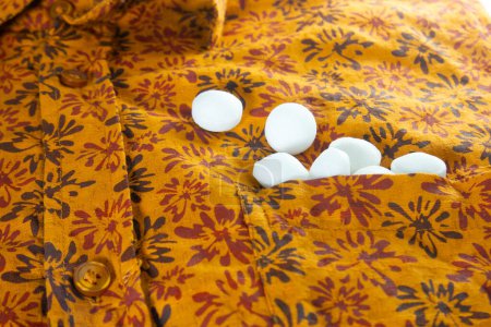 Photo for White naphthalene balls on cloth. - Royalty Free Image