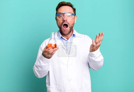 Photo for Middle age man feeling extremely shocked and surprised. scientist concept - Royalty Free Image