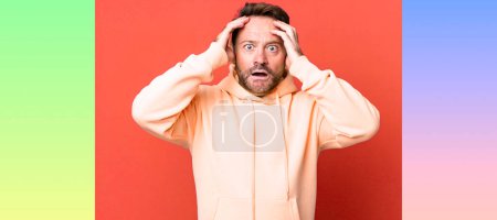 Photo for Feeling horrified and shocked, raising hands to head and panicking at a mistake - Royalty Free Image