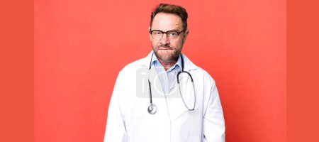 Photo for Middle age man looking puzzled and confused. physician concept - Royalty Free Image