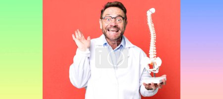 Photo for Middle age man feeling happy and astonished at something unbelievable. physician concept - Royalty Free Image