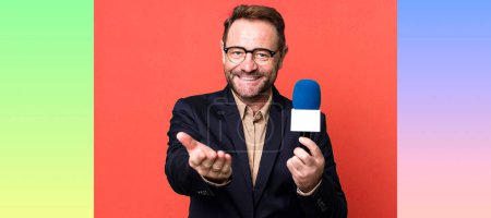 Photo for Middle age man smiling happily with friendly and  offering and showing a concept. journalist and a microphone concept - Royalty Free Image