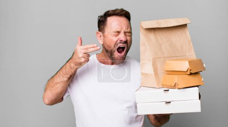 Photo for Middle age man looking unhappy and stressed, suicide gesture making gun sign. delivery and fast food take away concept - Royalty Free Image