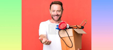 Photo for Middle age man smiling happily with friendly and  offering and showing a concept. handyman with a toolbox - Royalty Free Image