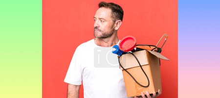 Photo for Middle age man on profile view thinking, imagining or daydreaming. handyman with a toolbox - Royalty Free Image