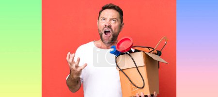 Photo for Middle age man looking desperate, frustrated and stressed. handyman with a toolbox - Royalty Free Image