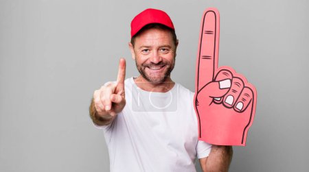 Photo for Middle age man smiling proudly and confidently making number one. number one fan concept - Royalty Free Image