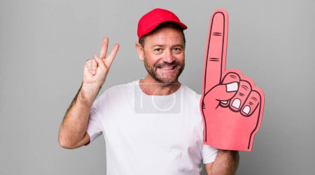 Photo for Middle age man smiling and looking friendly, showing number two. number one fan concept - Royalty Free Image