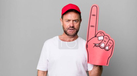 Photo for Middle age man feeling puzzled and confused. number one fan concept - Royalty Free Image