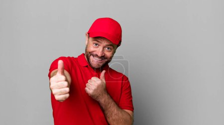Photo for Middle age man feeling proud,smiling positively with thumbs up. company employee - Royalty Free Image