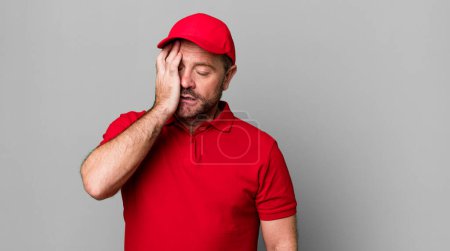 Photo for Middle age man feeling bored, frustrated and sleepy after a tiresome. company employee - Royalty Free Image