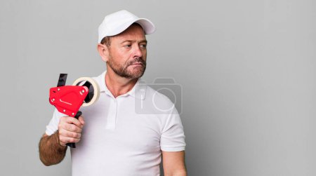 Photo for Middle age man feeling sad, upset or angry and looking to the side. company employee - Royalty Free Image