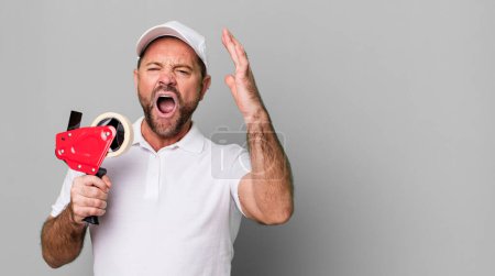 Photo for Middle age man screaming with hands up in the air. company employee - Royalty Free Image