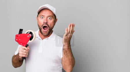 Photo for Middle age man feeling extremely shocked and surprised. company employee - Royalty Free Image
