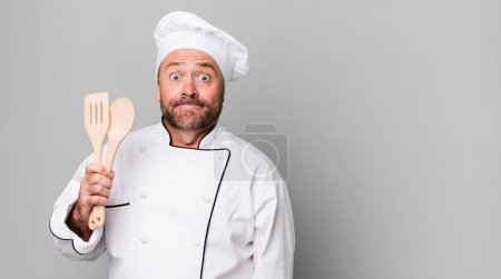 Photo for Middle age man shrugging, feeling confused and uncertain. chef and tools concept - Royalty Free Image