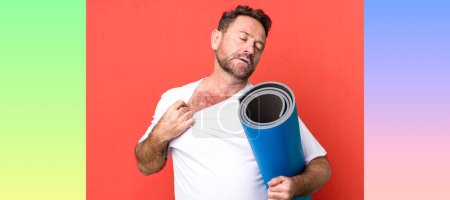Photo for Middle age man feeling stressed, anxious, tired and frustrated. with a yoga matt. fitness concept - Royalty Free Image