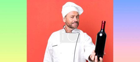 Photo for Middle age man chef concept and a wine bottle sport coach concept with a soccer ball - Royalty Free Image