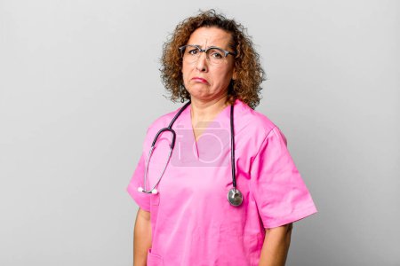 Photo for Pretty middle age woman feeling sad and whiney with an unhappy look and crying. nurse concept - Royalty Free Image