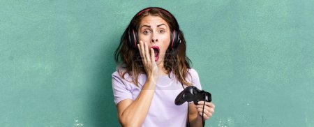 Photo for Hispanic pretty woman feeling shocked and scared. gamer concept - Royalty Free Image