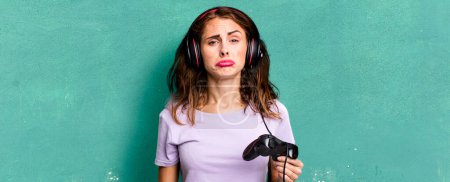 Photo for Hispanic pretty woman feeling sad and whiney with an unhappy look and crying. gamer concept - Royalty Free Image