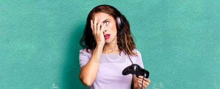 Photo for Hispanic pretty woman feeling bored, frustrated and sleepy after a tiresome. gamer concept - Royalty Free Image