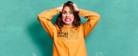 Photo for Hispanic pretty woman feeling stressed, anxious or scared, with hands on head. guilt concept - Royalty Free Image