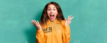 Photo for Hispanic pretty woman feeling happy and astonished at something unbelievable. guilt concept - Royalty Free Image